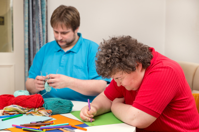 woman and young man doing arts and crafts