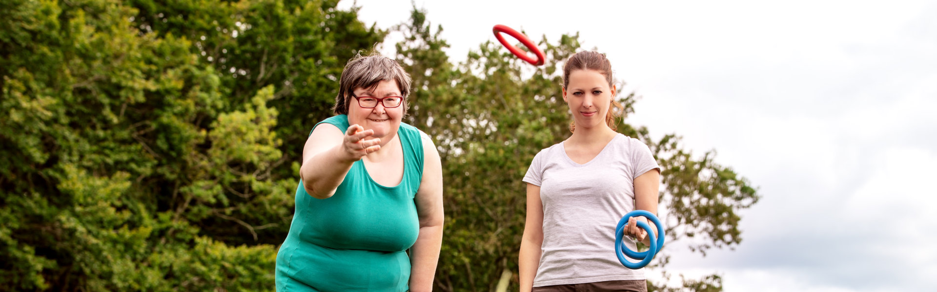 smiling woman with her friend playing outside